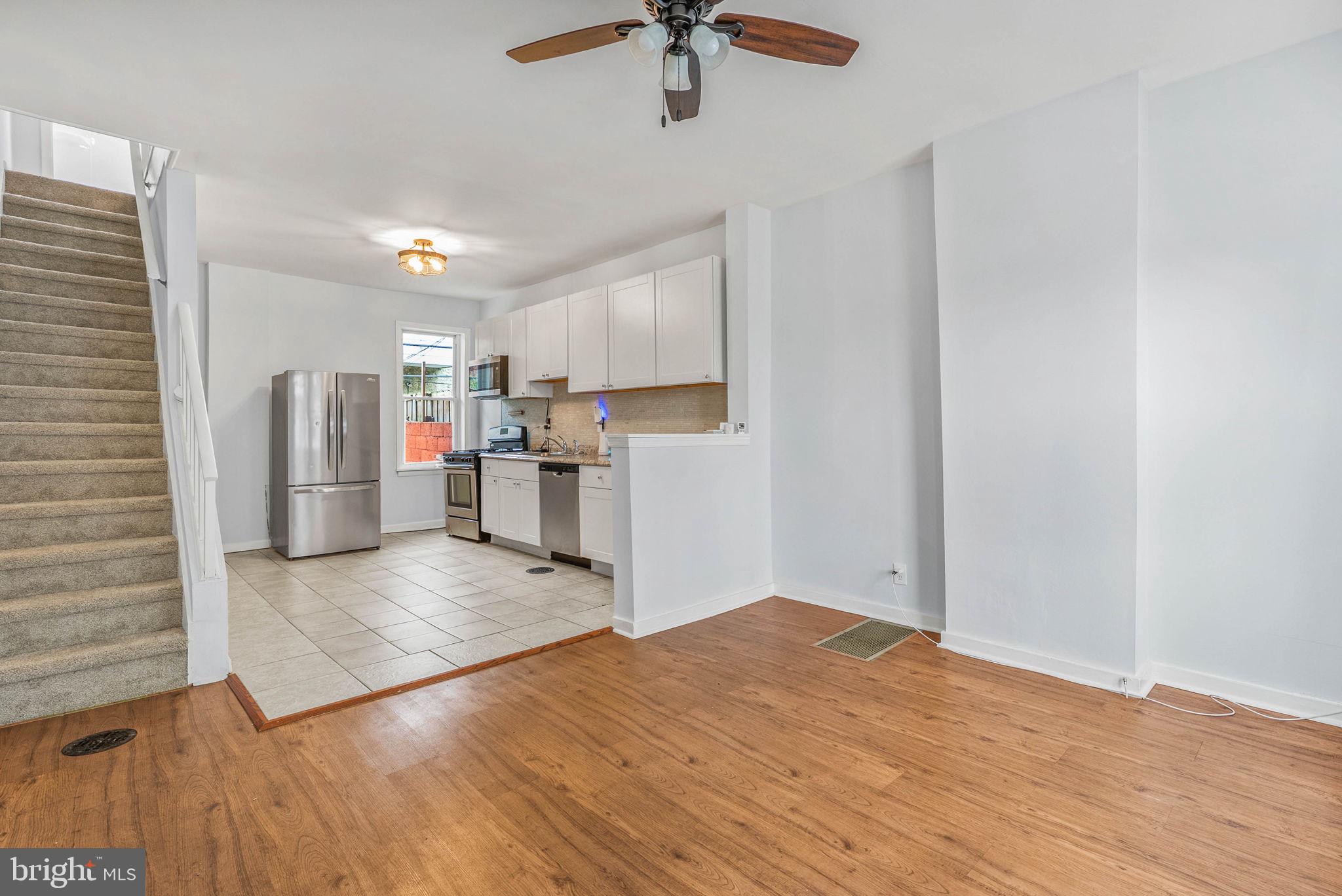 2951 Gerritt Street Philadelphia, PA 19146 - Photo 4 of 21 a view of a kitchen with a refrigerator a ceiling fan and wooden floor