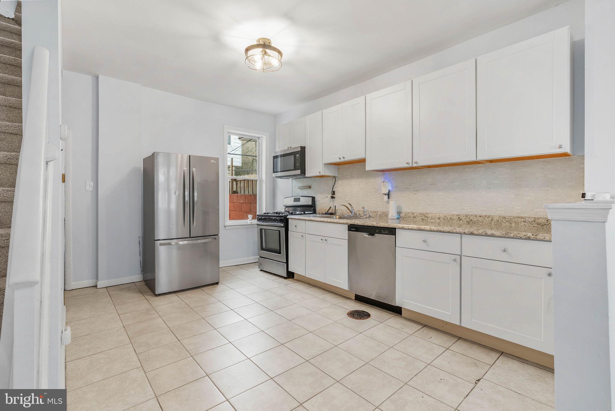 2951 Gerritt Street Philadelphia, PA 19146 - Photo 8 of 21 a kitchen with a refrigerator sink and cabinets