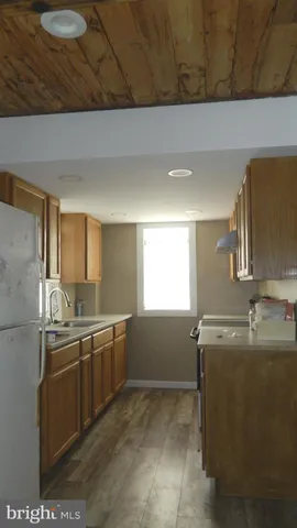 a kitchen with stainless steel appliances granite countertop a sink and a refrigerator
