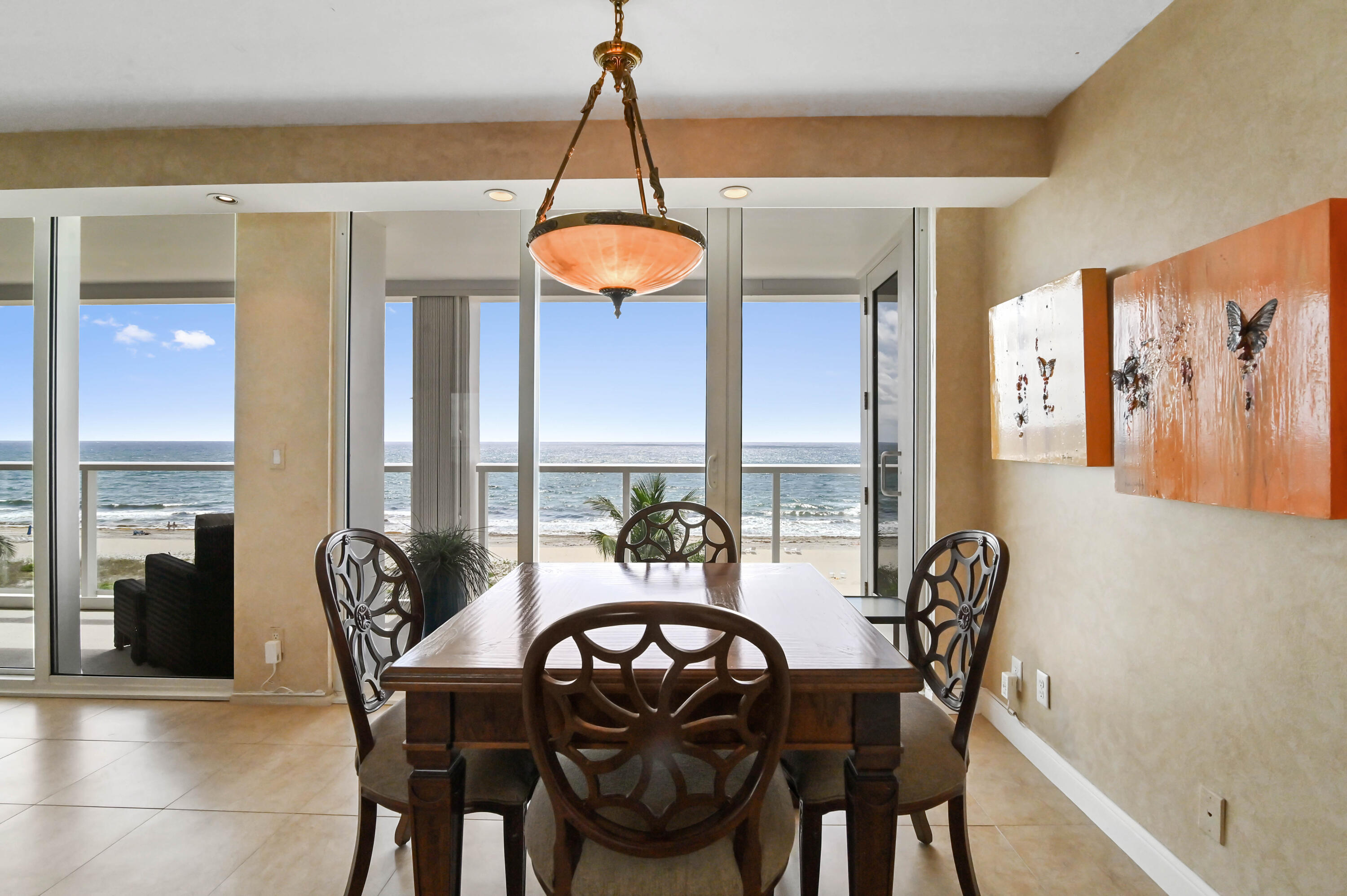 2800 South Ocean Boulevard, Unit 5J Boca Raton, FL 33432 - Photo 7 of 56 a dining room with furniture a chandelier and wooden floor