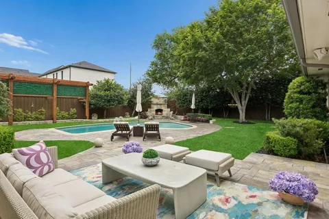 a view of a patio with table and chairs potted plants with wooden fence