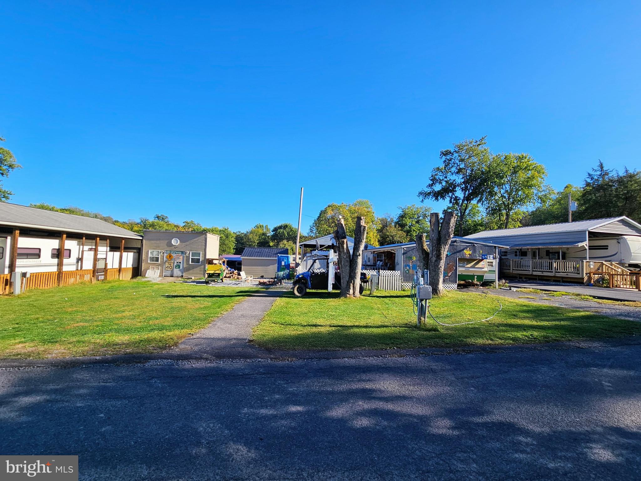 a front view of a house with a yard and trees