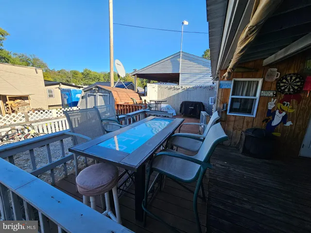 a view of a chairs and table in the balcony