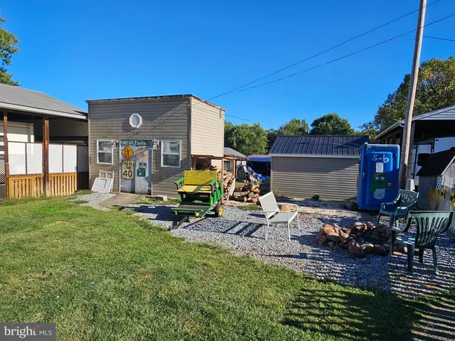 a view of a house with backyard porch and sitting area