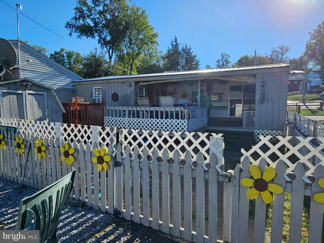 a view of a house with wooden fence