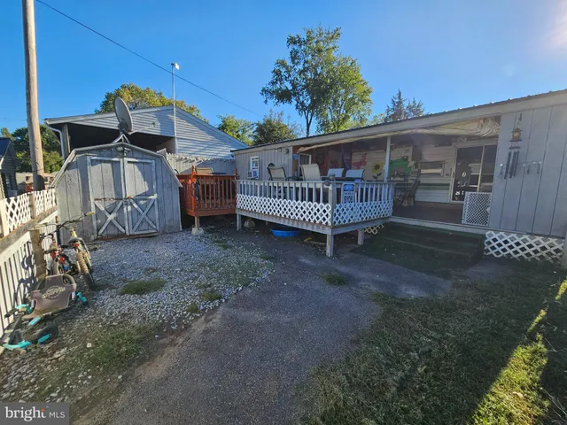 a view of a house with a yard and deck area