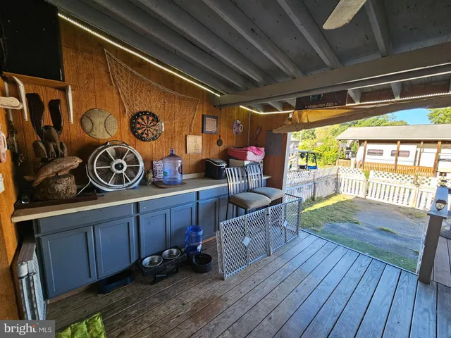 a view of a room with wooden floor and furniture