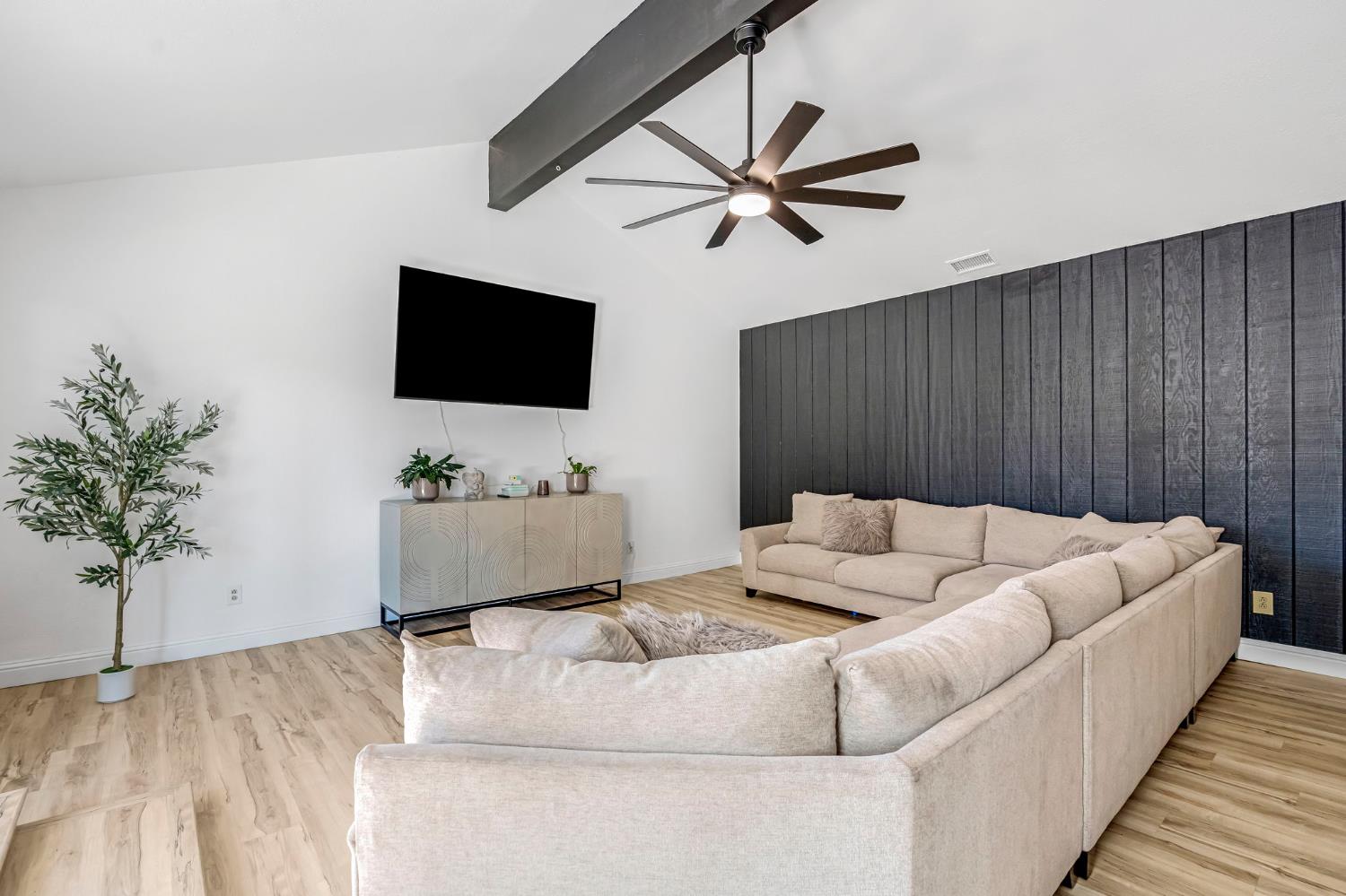 2428 West 3rd Street Madera, CA 93637 - Photo 11 of 39 a living room with furniture and a flat screen tv
