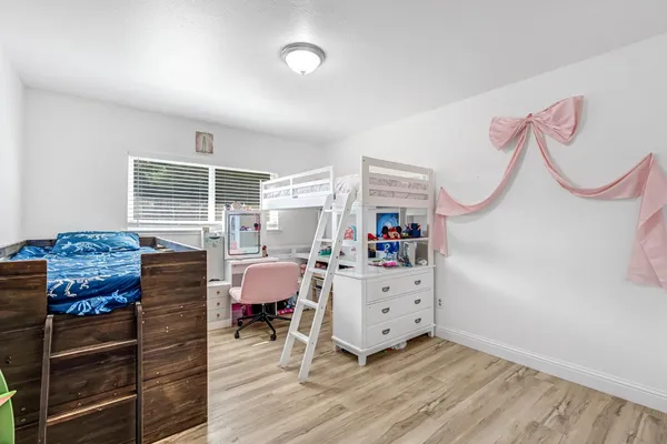 a bedroom with furniture and a window