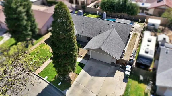 an aerial view of a house with a yard basket ball court and street view