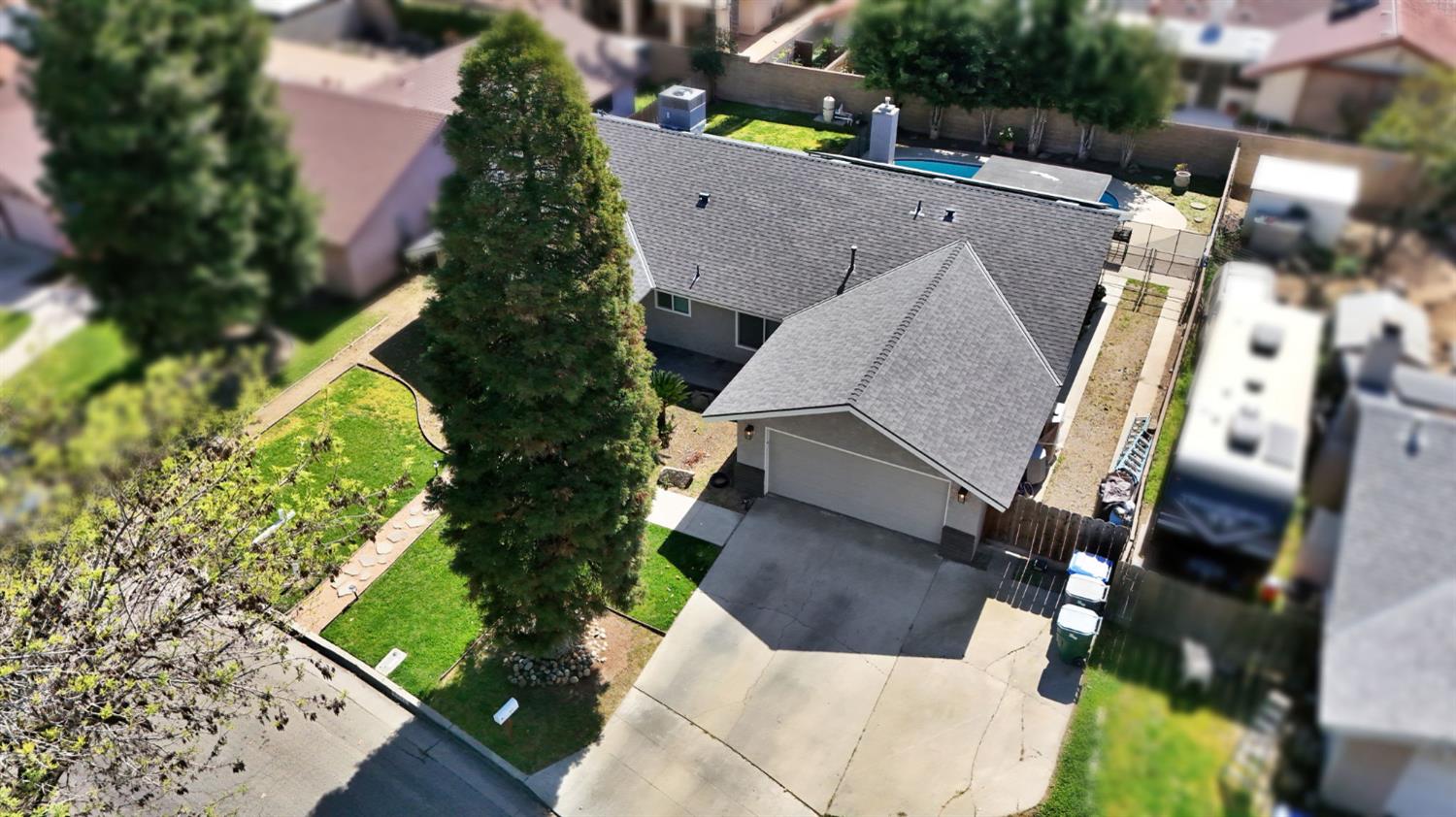 2428 West 3rd Street Madera, CA 93637 - Photo 35 of 39 an aerial view of a house with a yard basket ball court and street view