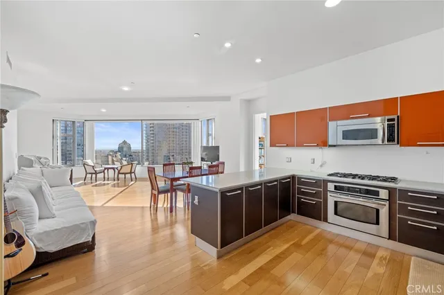 a view of a kitchen with furniture and wooden floor