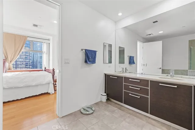 a spacious bathroom with a tub sink and mirror