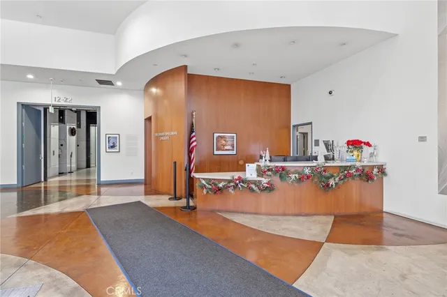 a living room with furniture and floor to ceiling windows