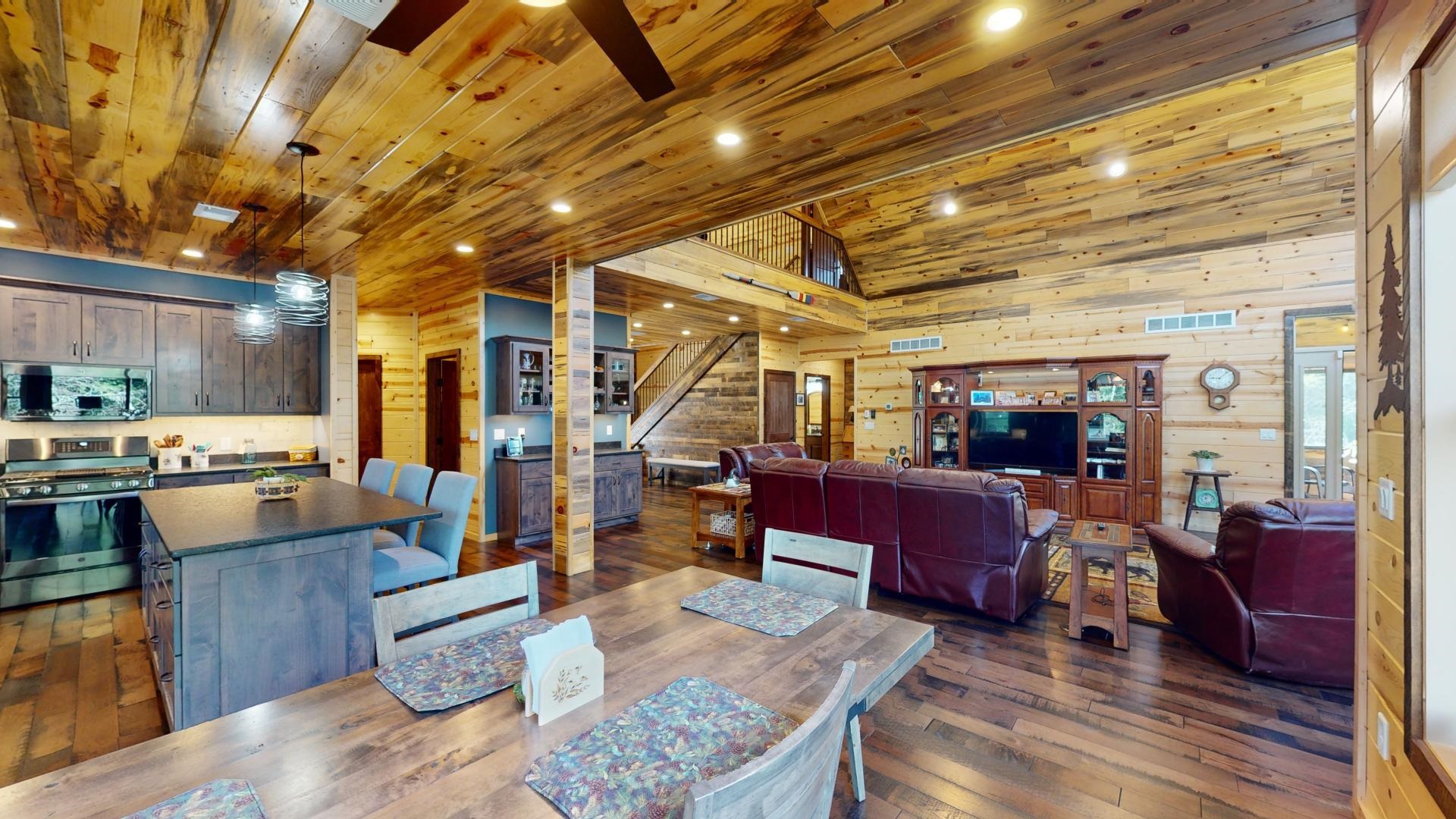 7523 Nelson Road Crane Lake, MN 55725 - Photo 15 of 50 Dining area with stairs, wood ceiling, wood walls, visible vents, and dark wood-style flooring