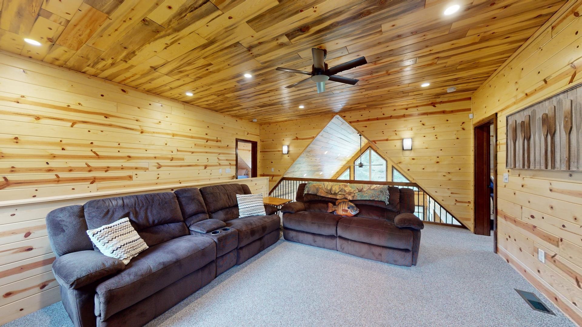 7523 Nelson Road Crane Lake, MN 55725 - Photo 31 of 50 Living room with carpet, wood ceiling, wooden walls, visible vents, and ceiling fan