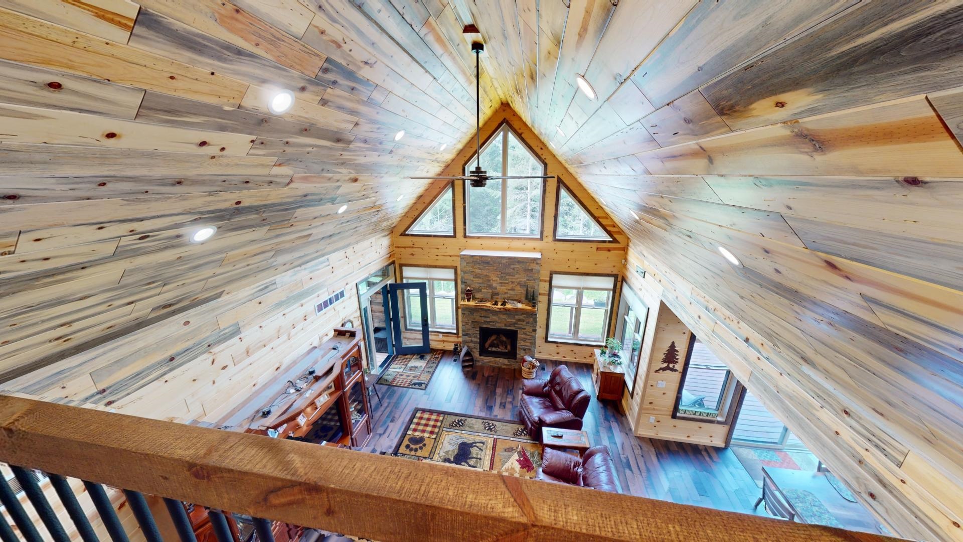 7523 Nelson Road Crane Lake, MN 55725 - Photo 32 of 50 Living room featuring high vaulted ceiling, wood walls, a fireplace, hardwood / wood-style floors, and wood ceiling