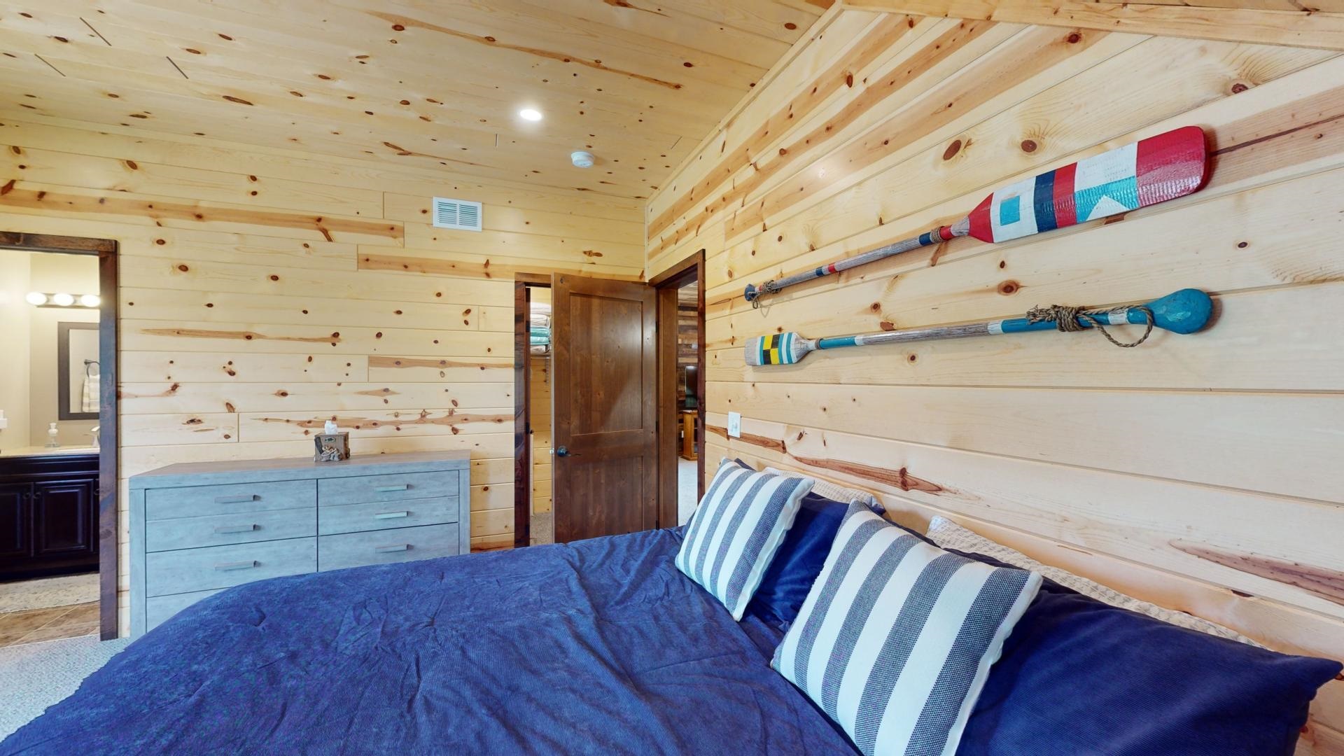 7523 Nelson Road Crane Lake, MN 55725 - Photo 37 of 50 Bedroom with ensuite bath, visible vents, wood walls, and wood ceiling