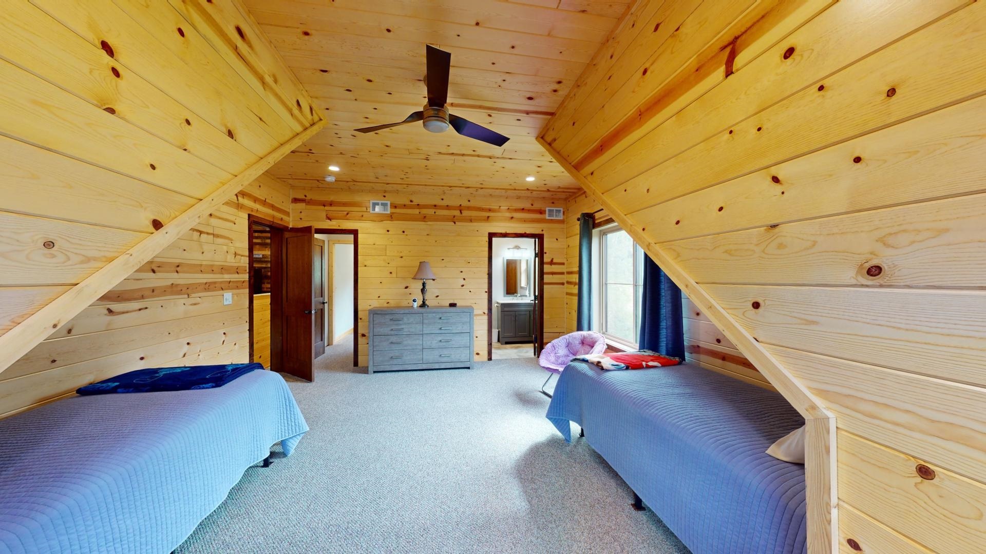 7523 Nelson Road Crane Lake, MN 55725 - Photo 40 of 50 Bedroom featuring visible vents, wood walls, lofted ceiling, wood ceiling, and light colored carpet