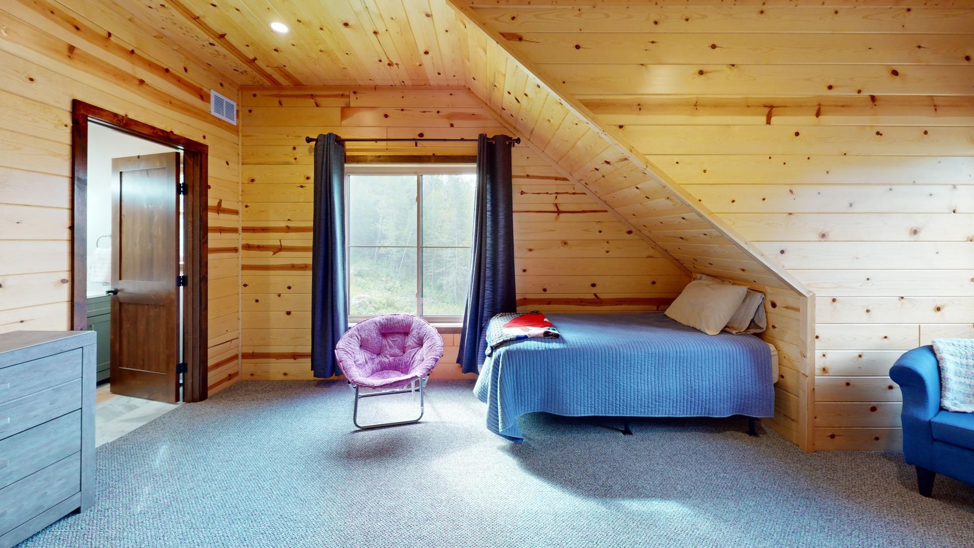 7523 Nelson Road Crane Lake, MN 55725 - Photo 42 of 50 Bedroom featuring carpet, wooden walls, and visible vents