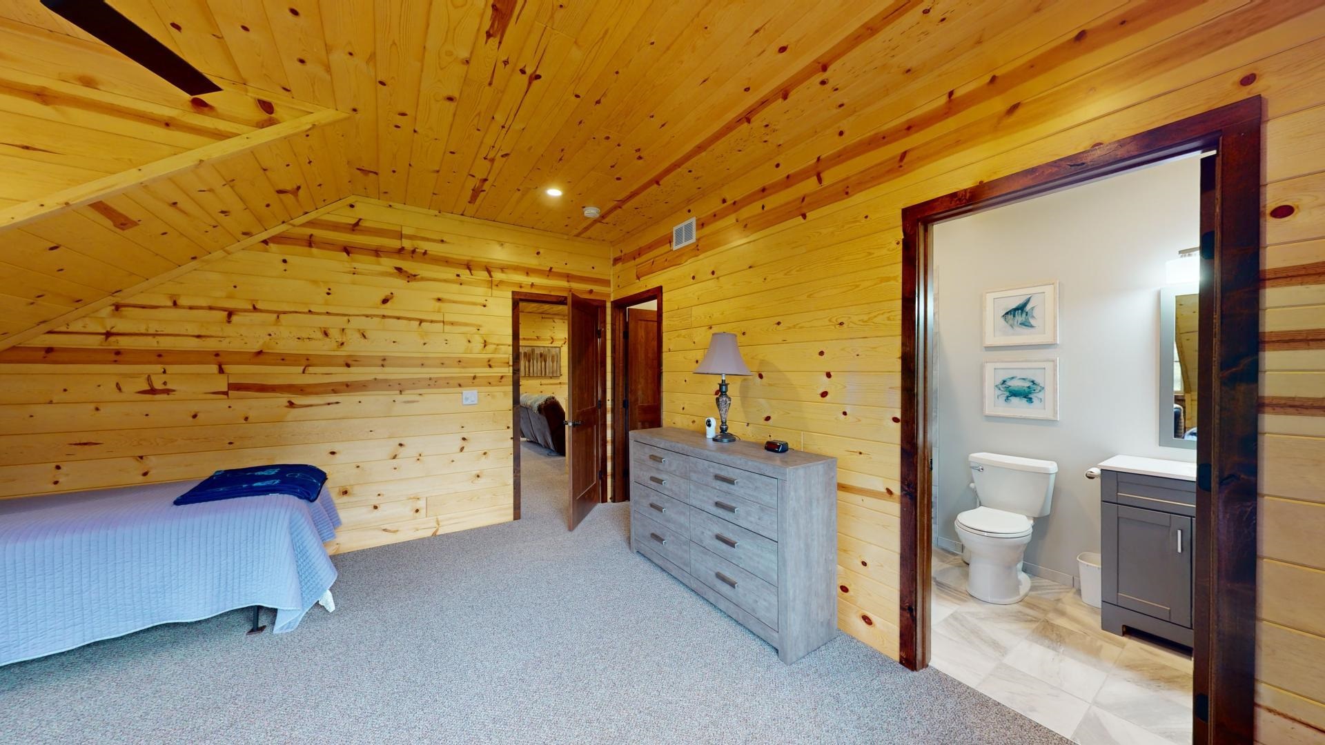 7523 Nelson Road Crane Lake, MN 55725 - Photo 43 of 50 Bedroom with lofted ceiling, wood ceiling, wooden walls, visible vents, and ensuite bathroom