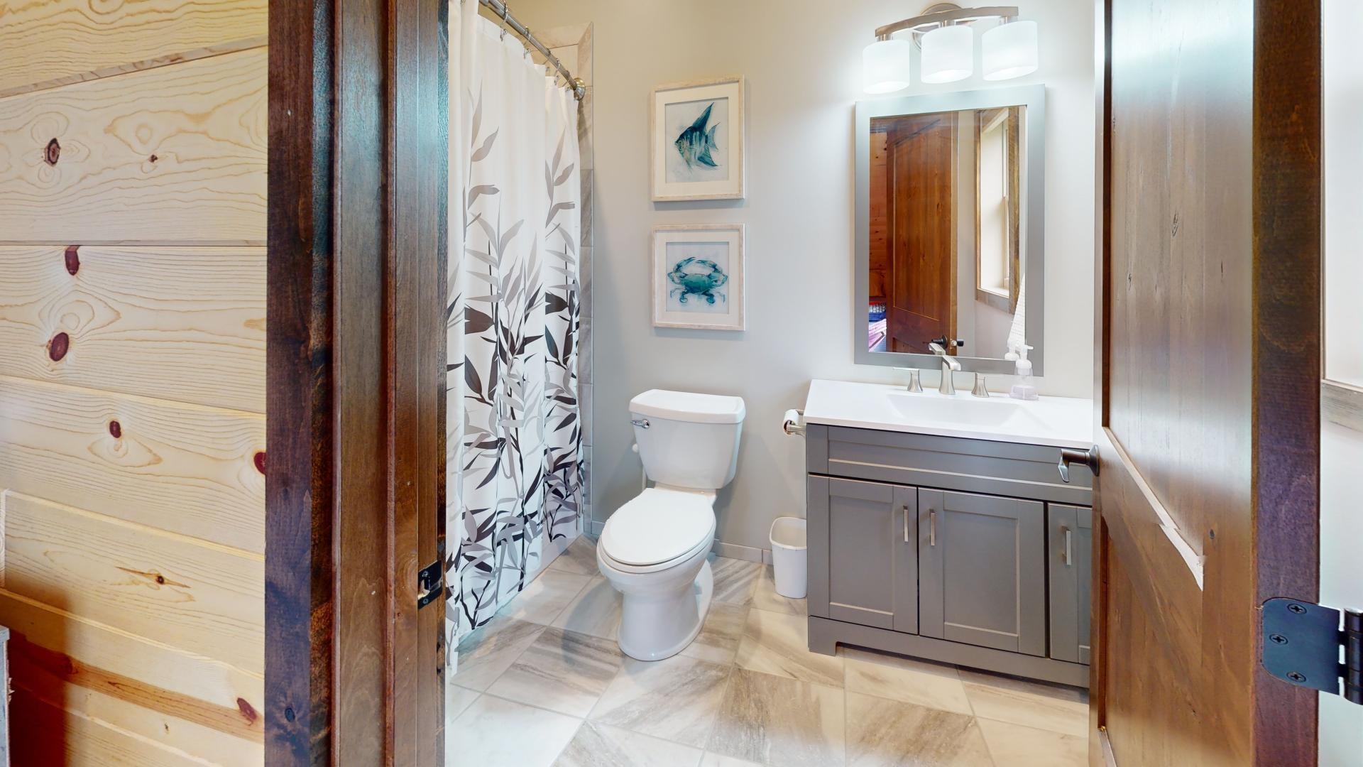 7523 Nelson Road Crane Lake, MN 55725 - Photo 44 of 50 Bathroom featuring baseboards, toilet, a shower with shower curtain, and vanity