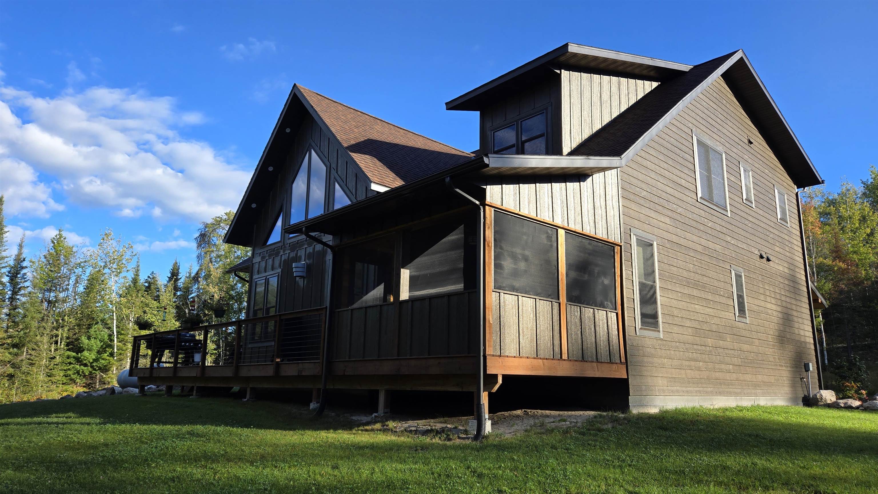 7523 Nelson Road Crane Lake, MN 55725 - Photo 5 of 50 View of side of home featuring a sunroom and a yard