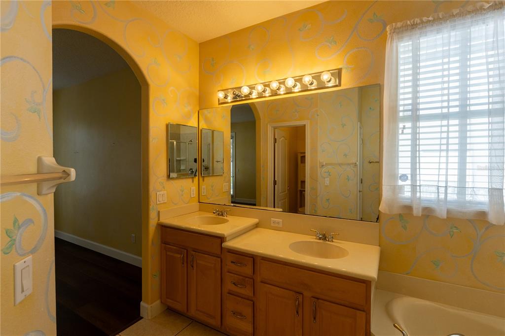 65 Calliope Street Ocoee, FL 34761 - Photo 21 of 60 a bathroom with a double vanity sink a mirror and a shower