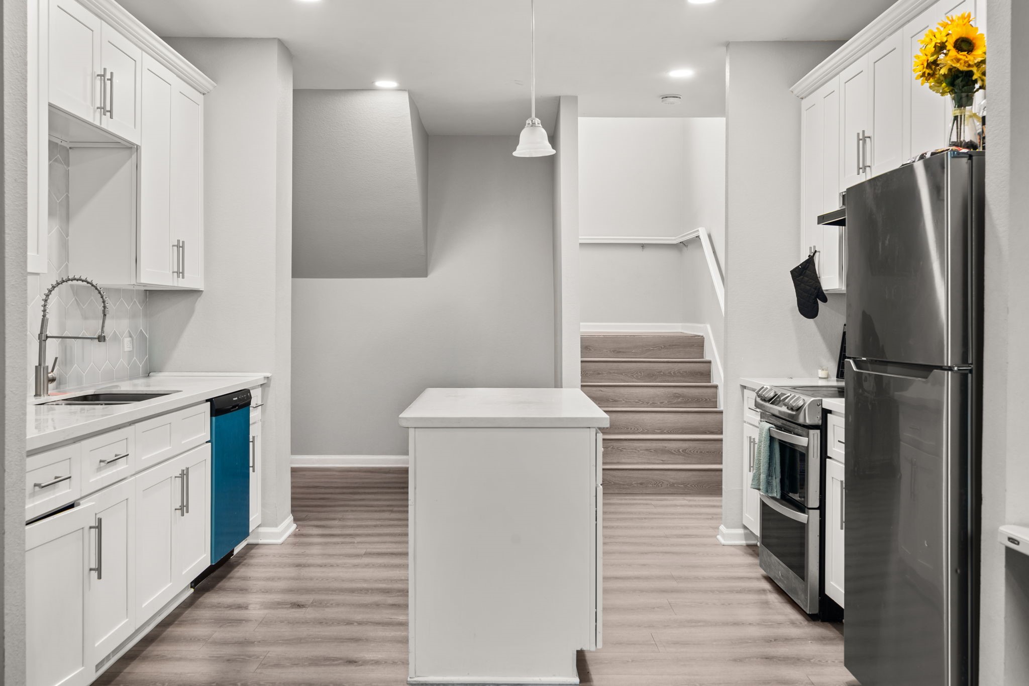 8534 Woodlyn Road Houston, TX 77028 - Photo 11 of 25 a kitchen with a refrigerator sink and wooden cabinets