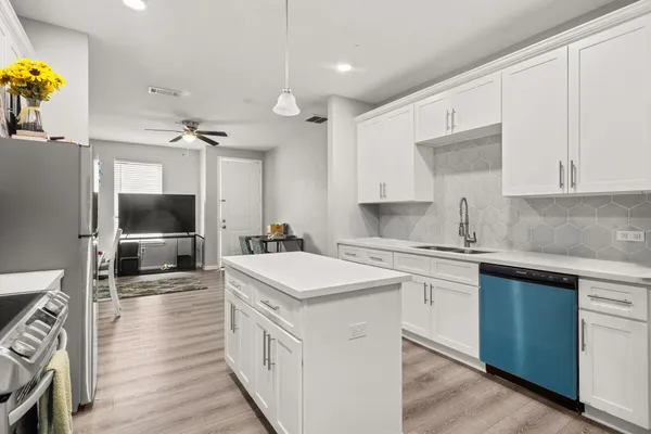 a kitchen with a sink and a stove top oven