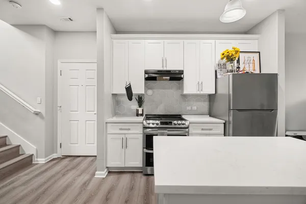 a kitchen with cabinets and stainless steel appliances
