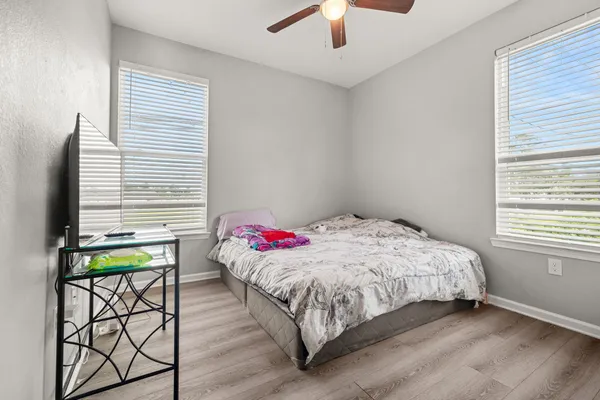 a bedroom with a bed and a window