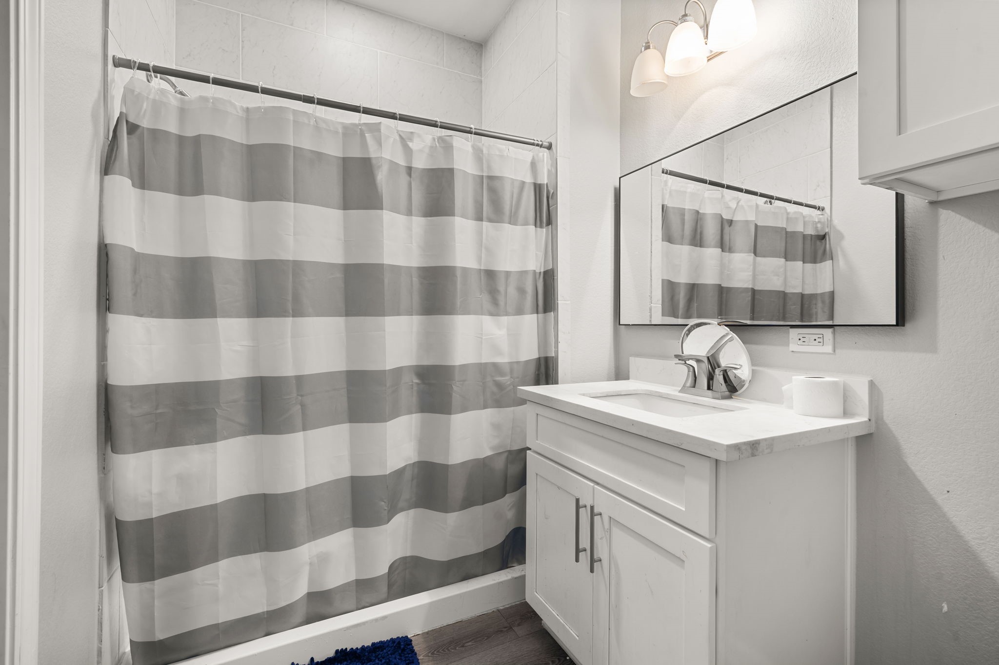 8534 Woodlyn Road Houston, TX 77028 - Photo 22 of 25 a bathroom with a sink a toilet a mirror and shower curtain