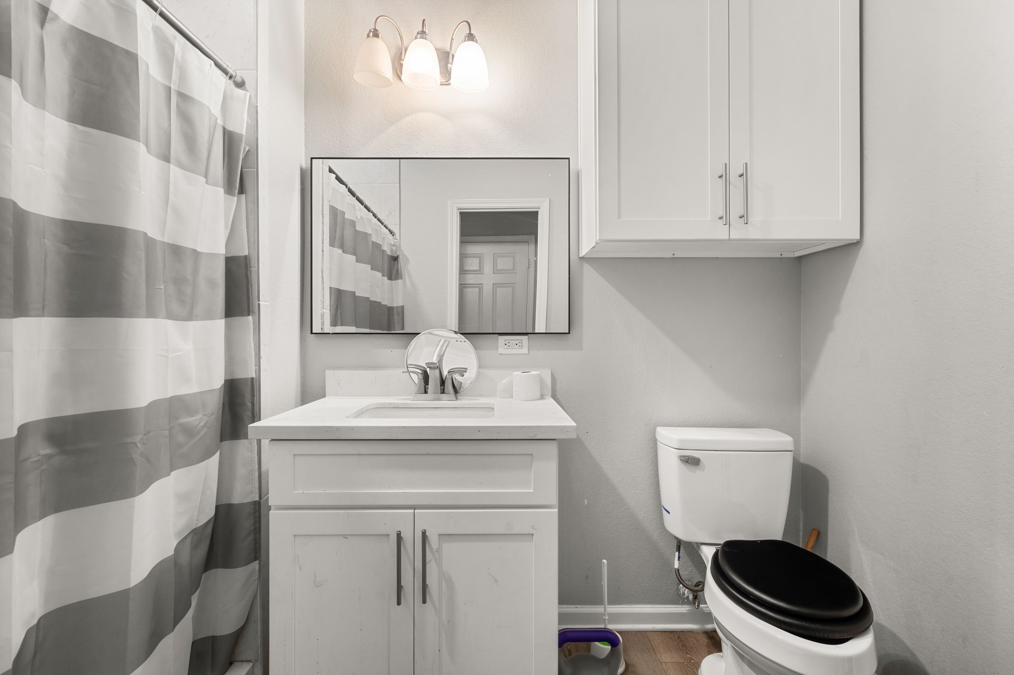 8534 Woodlyn Road Houston, TX 77028 - Photo 23 of 25 a bathroom with a toilet a sink and a mirror