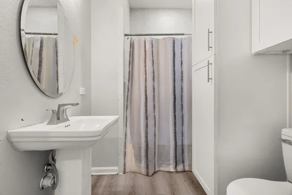 a bathroom with a sink a toilet and a mirror