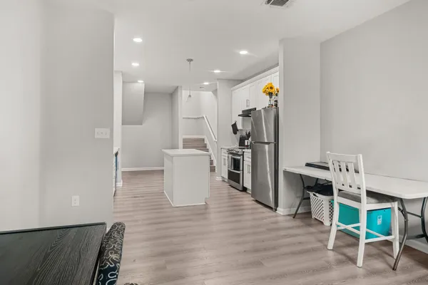a living room with furniture and kitchen view