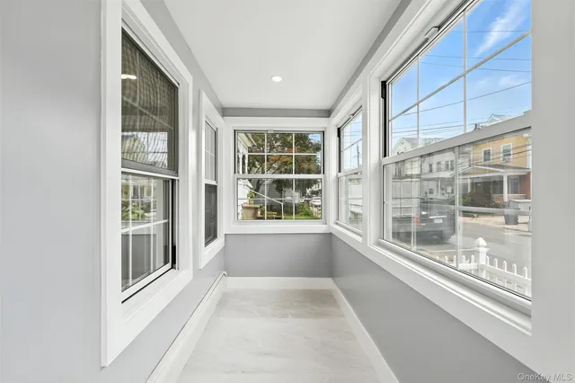 a view of an entryway with wooden floor and windows