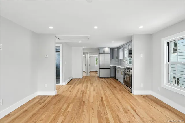a view of an empty room with wooden floor