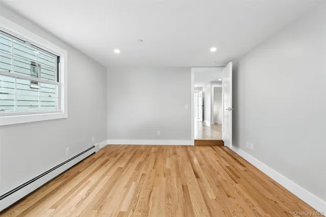 a view of a room with wooden floor and window