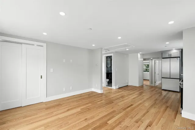 a view of an empty room with wooden floor