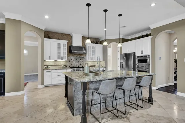 a large kitchen with a large counter top and appliances