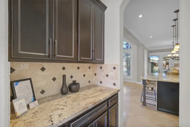 a view of a dining room with furniture wooden floor and a chandelier