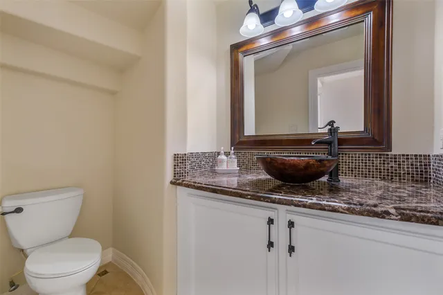 a bedroom with a bed chandelier and a window