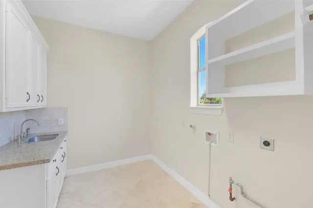 a bathroom with a granite countertop double vanity sink and a mirror