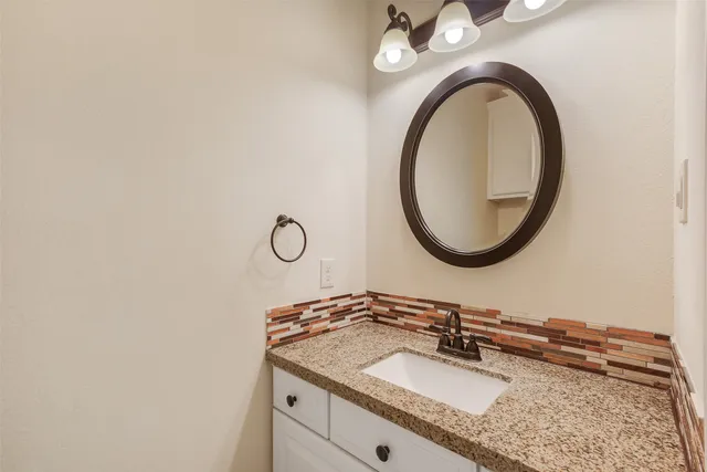a bathroom with a sink a vanity and a mirror