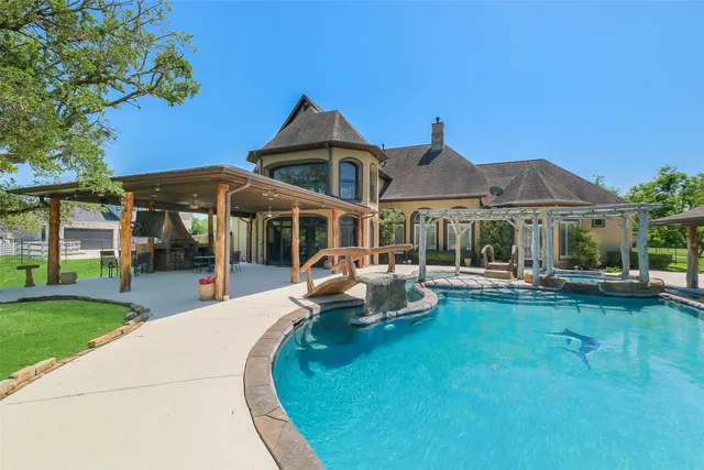 a view of a house with backyard porch and sitting area