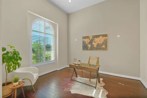 a living room with furniture a fireplace and a chandelier