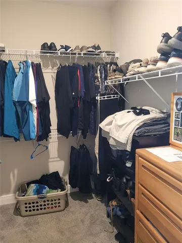 a bathroom with a granite countertop sink a toilet and shower