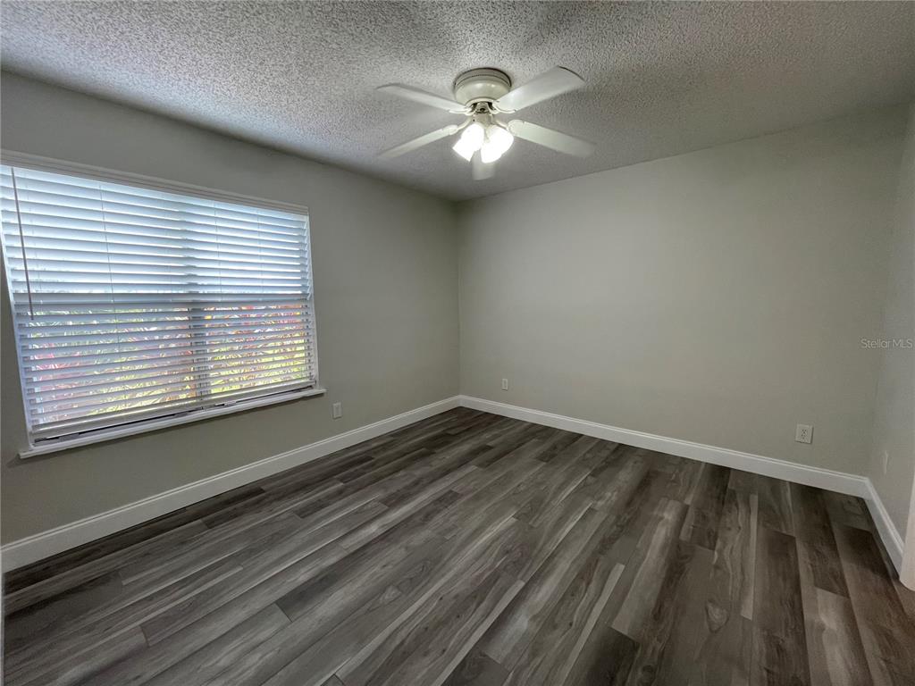 1600 Big Tree Road, Unit H3 South Daytona, FL 32119 - Photo 11 of 18 a view of an empty room with wooden floor and a window
