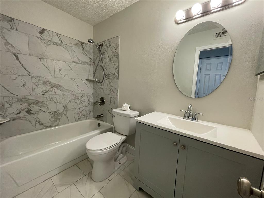 1600 Big Tree Road, Unit H3 South Daytona, FL 32119 - Photo 12 of 18 a bathroom with a toilet sink and mirror